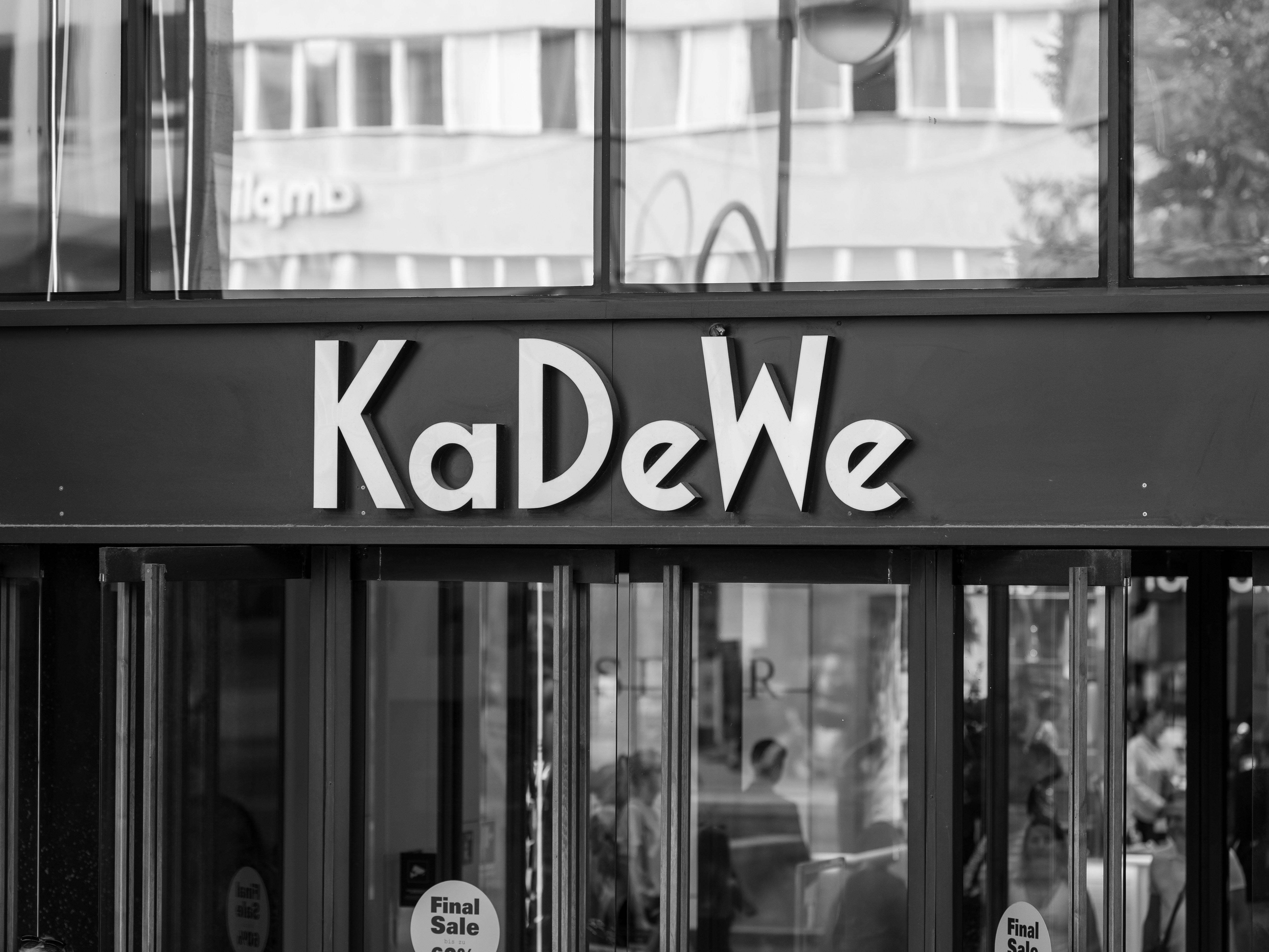 Kadewe department store entrance in black and white.